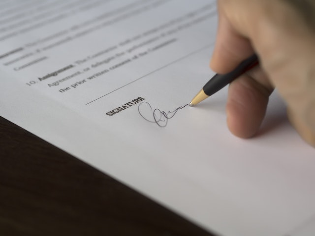 person-signing-their-signature-on-a-contract person-signing-their-signature-on-a-contract